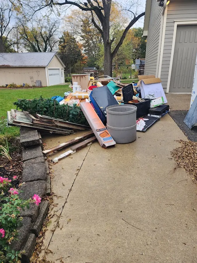 Dumpster being loaded with debris for 10 Yard Dumpster Rental in Jemison
